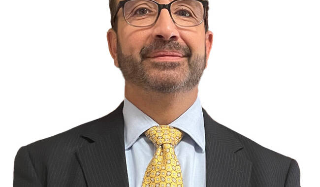man with glasses wearing suit and tie