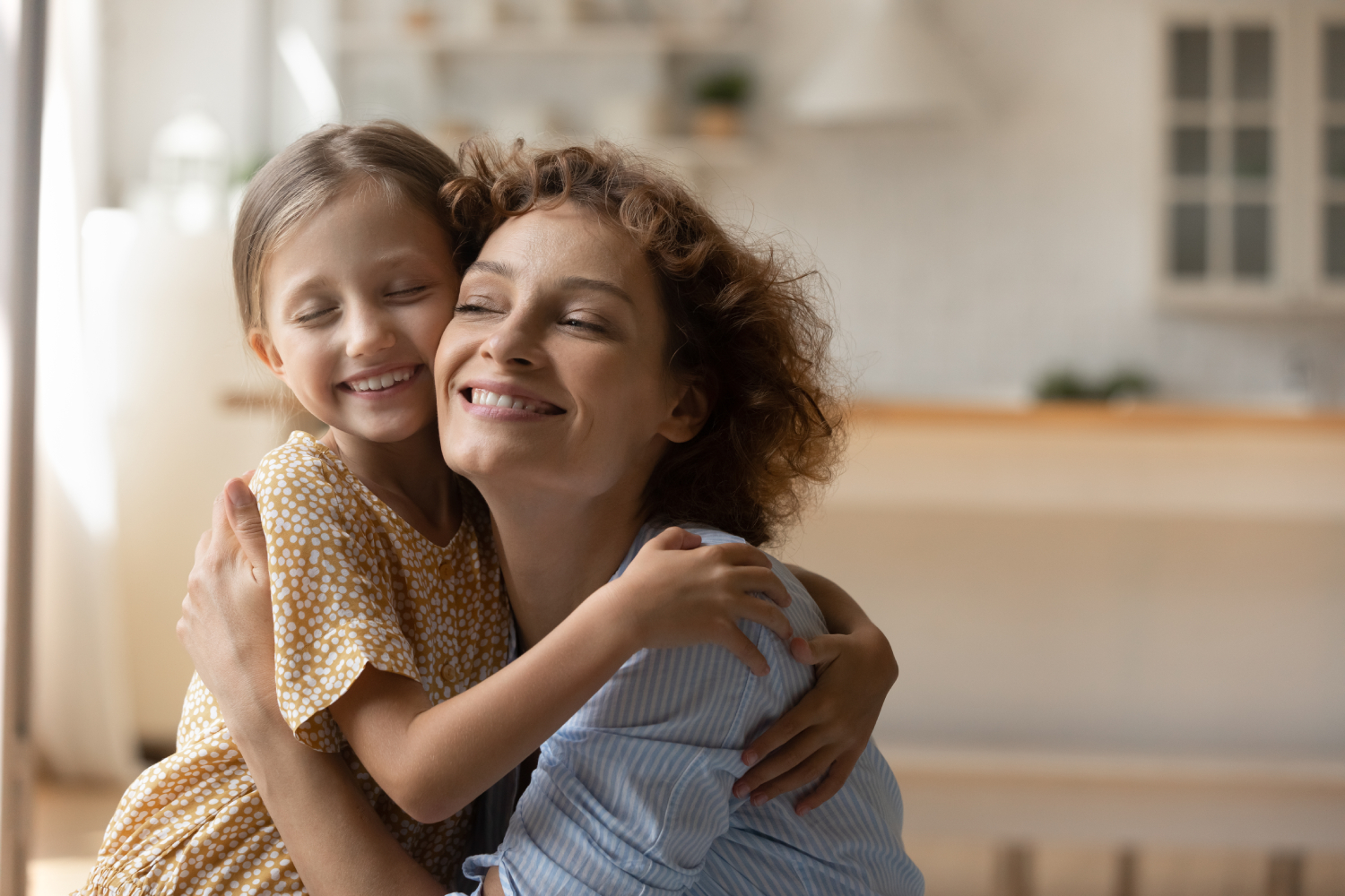 Woman and little girl hugging